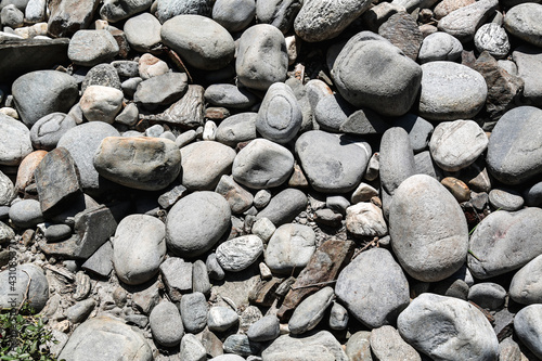 A cluster of pebbles of different sizes and shapes on a dried up river bed in the Himalayas.