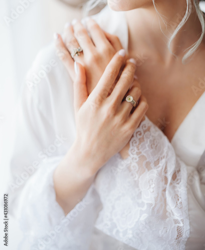 Bride in the white robe folded her arms over her chest. Wedding preparations