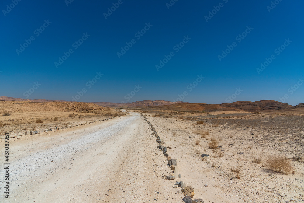 A view from the crater in the Ramon Crater. Arid desert view. White sands and a horizon of blue skies. Negev, Israel. High quality photo
