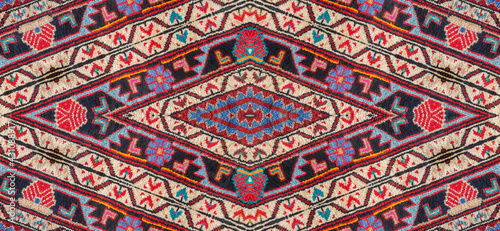 Kaleidoscopic Close-up pattern of a Persian handmade carpet border © Baharlou