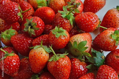 Beautiful red skin of fresh strawberry fruit close up