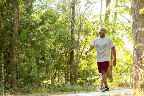 Mature African American man taking a walk outside.