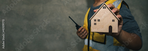 Photos Engineering holding wooden modern house for fix and renovation real estate property