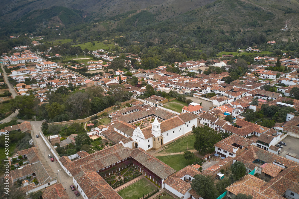 Aerial view of a monastery surrounded by Spanish colonial style houses in the town of Villa de Leyva. Colombia.