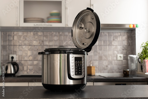 Modern multi cooker in kitchen. Open, ready to cook. photo
