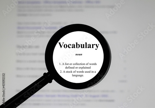 Selective focus on word vocabulary, word in a dictionary. Close up of an English dictionary page with the word vocabulary