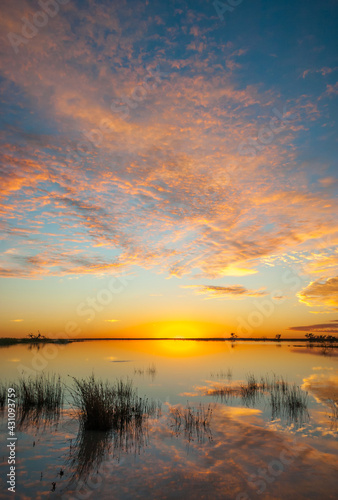 Sunrise over Coongie Lakes in the central desert area of Australia with the clouds turning orange