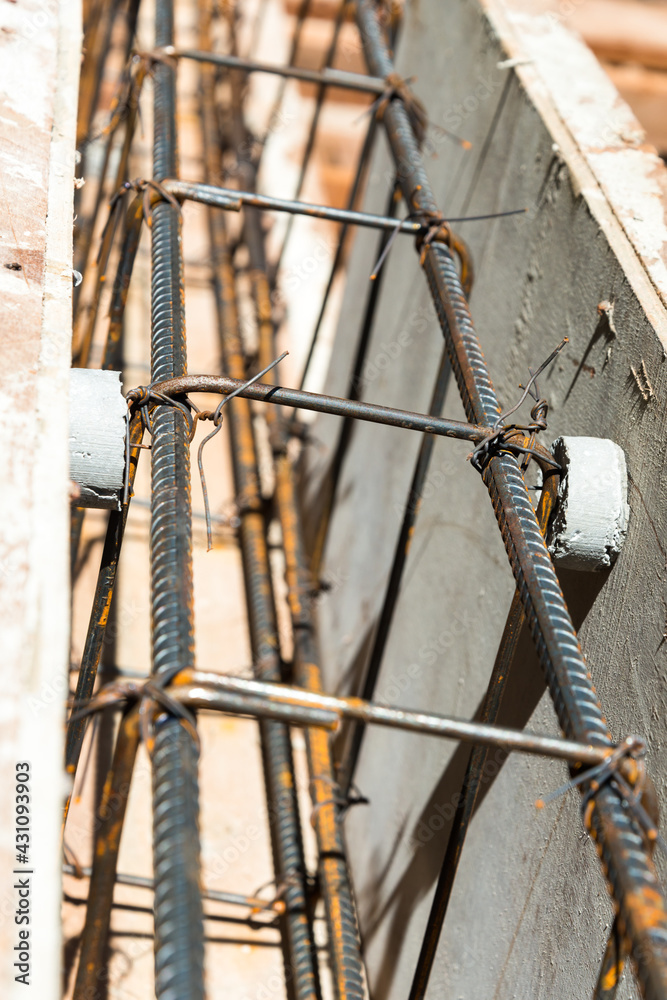 The rounded concrete rebar chair for supporting rebar to make correct alignment before pouring concrete of a house foundation.