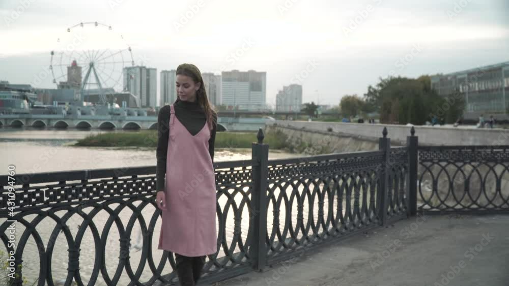 A girl goes and walks on a bridge in the city. 4k A girl goes and walks on a bridge in the city. 4k