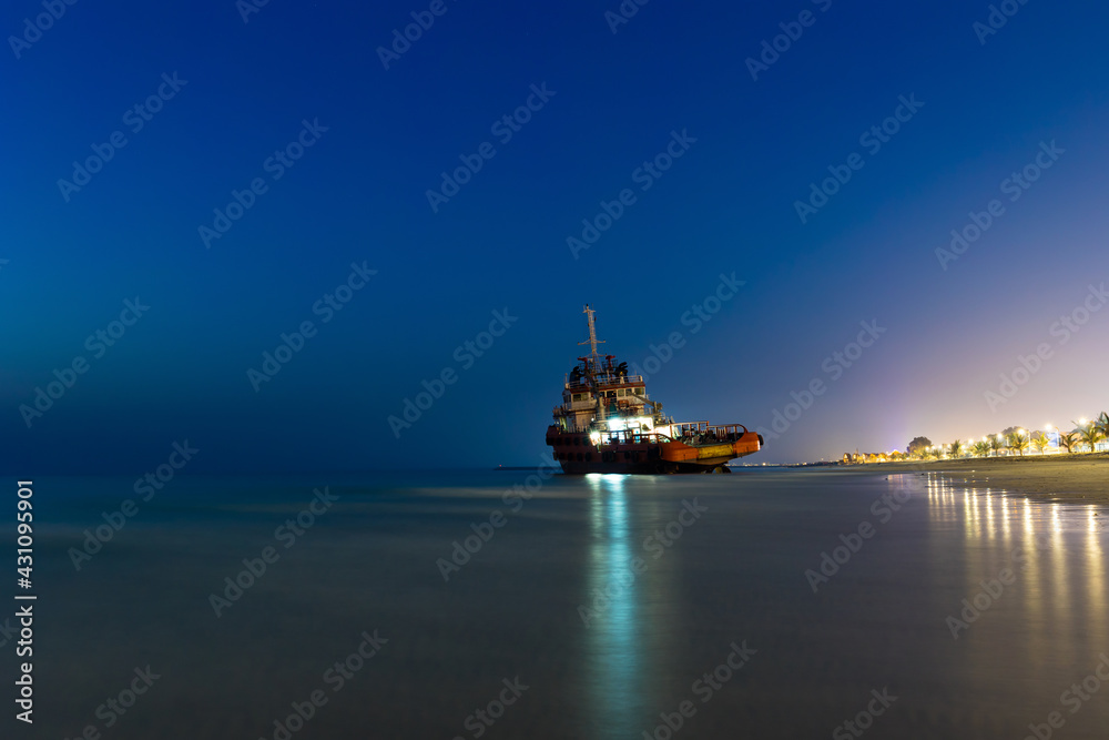 Ship Wreck along the Umm Al Quwain Coast in UAE. A stranded or abandoned vessel on the beach. Long Exposure Shot.