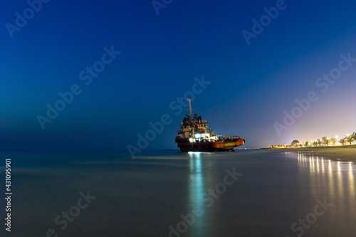 Ship Wreck along the Umm Al Quwain Coast in UAE. A stranded or abandoned vessel on the beach. Long Exposure Shot. photo
