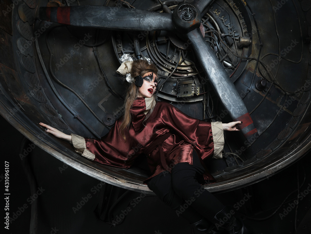 Aggressive stylish steampunk lady in a creative interior. Aggressive stylish steampunk lady in a creative interior.