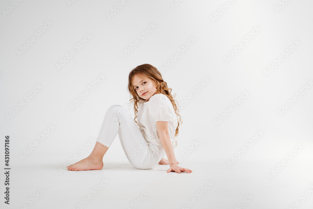 barefoot little girl with long hair in white clothes.shampoo for children's hair barefoot little girl with long hair in white clothes.shampoo for children's hair