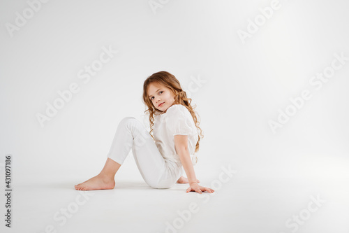 barefoot little girl with long hair in white clothes.shampoo for children's hair