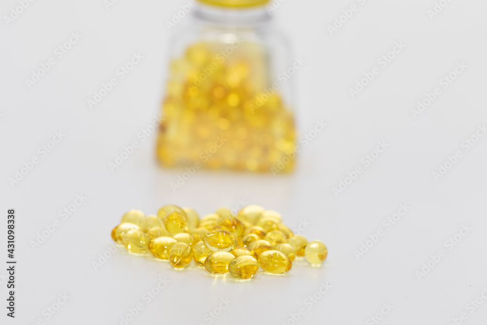 Cod liver oil capsules bottle containing cod liver capsules with some capsules kept outside
Cod liver oil capsules bottle containing cod liver capsules with some capsules kept outside