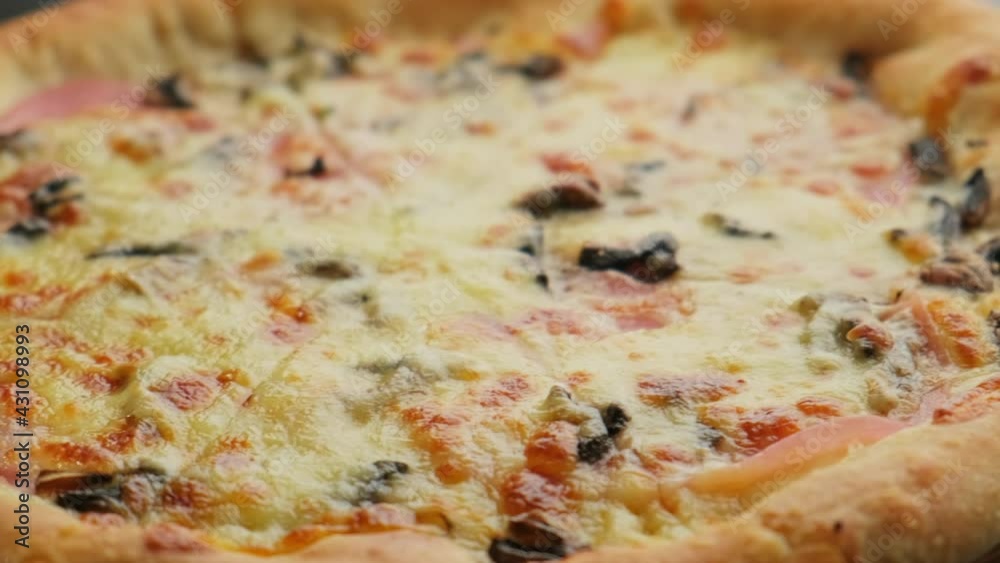 Freshly cooked cheese pizza on a wooden board on a black background. Italian cuisine. Freshly cooked cheese pizza on a wooden board on a black background. Italian cuisine.