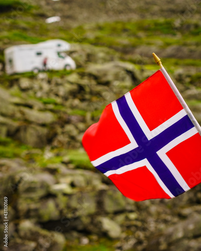 Norwegian flag and camper car in mountains photo