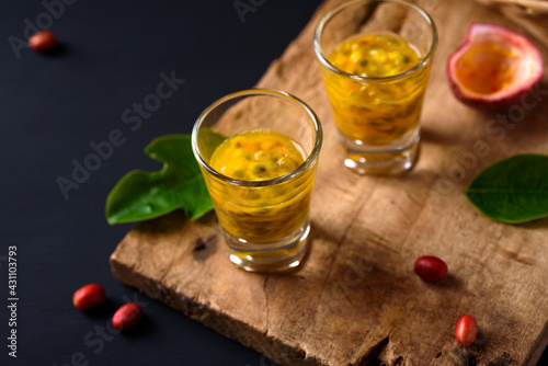 Fresh passion fruit juice in a glass on wooden, Healthy tropical drink