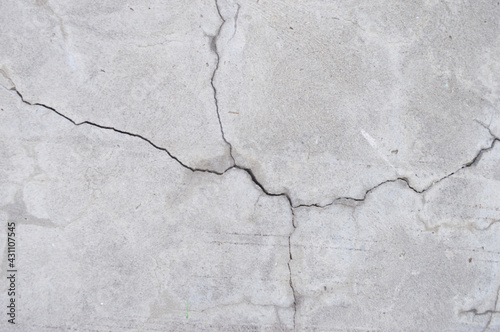 Crack wall texture. Cracked concrete wall covered with cement surface as background. Wall fragment with scratches and cracks