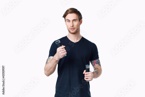 a man in a black T-shirt with dumbbells in his hands Sport Fitness Model