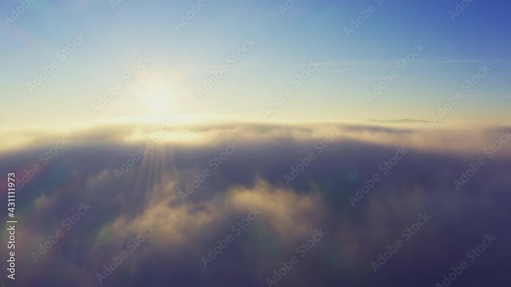 A beautiful and gentle view of an extraordinary and fluffy cloud valley and a bright orange sunset, aerial UHD 4K video A beautiful and gentle view of an extraordinary and fluffy cloud valley and a bright orange sunset, aerial UHD 4K video