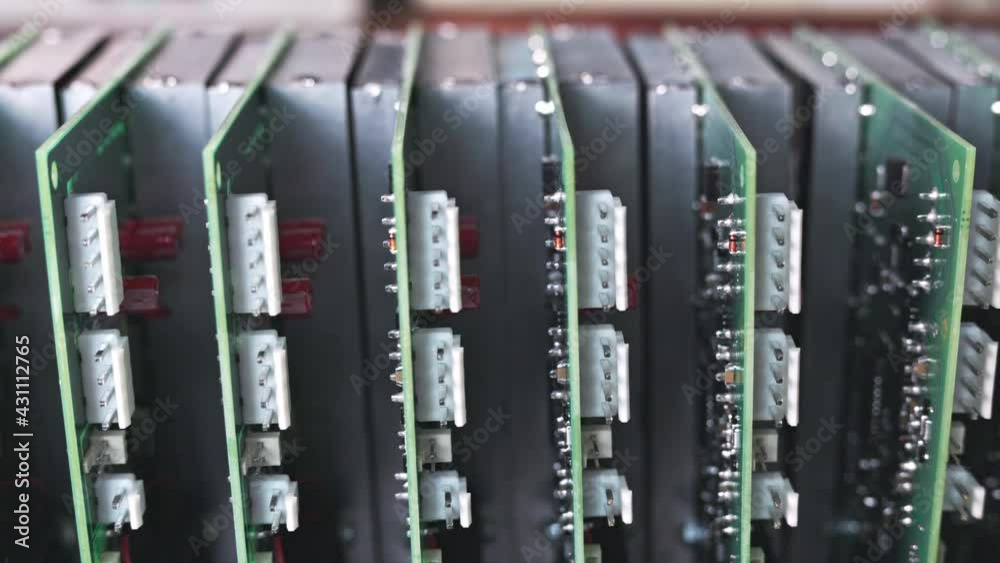Slider shot video of electronic digital PCB boards on workshop table. Metal components and microcircuits lie on metal compartments during the production of cases of future powerful supercomputers Slider shot video of electronic digital PCB boards on workshop table. Metal components and microcircuits lie on metal compartments during the production of cases of future powerful supercomputers