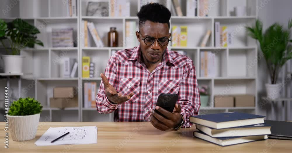 Young African man upset on app crashed in smartphone Young African man upset on app crashed in smartphone