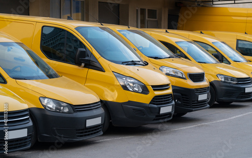 Yellow delivery vans parked in a row 