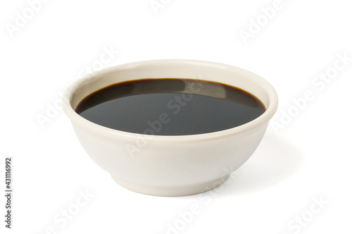 soy sauce on a white background. in a white plate or bowl, dark brown sauce