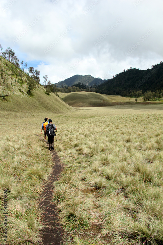 Malang, Indonesia – June 8, 2013: A group of people walking along the grasslands of Mount Semeru, East Java, Indonesia