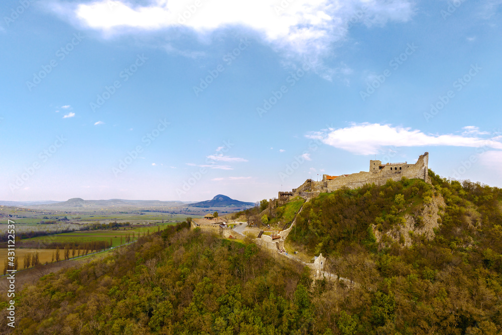 The Castle of Szigliget with Badacsony mountain next to lake Balaton in Hungary. Hisorical monument fortress ruins. Built was in 11 century, destroyed in 16.