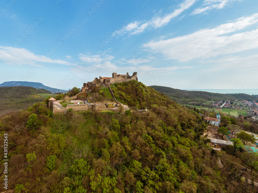 The Castle of Szigliget with Badacsony mountain next to lake Balaton in Hungary. Hisorical monument fortress ruins. Built was in 11 century, destroyed in 16.
