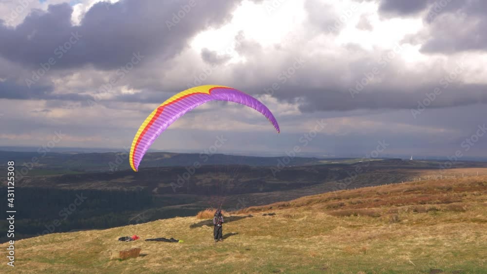 Paragliding pilot on high landscape waiting take off Paragliding pilot on high landscape waiting take off