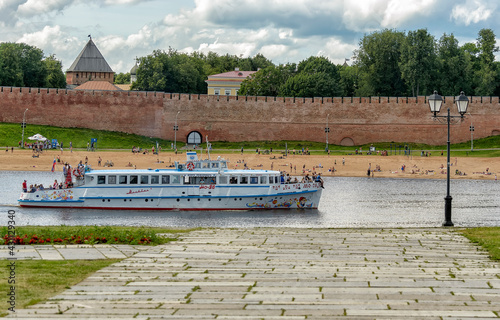 View of the Pokrovskaya Tower and the Kremlin wall of Veliky Novgorod from the right bank of the Volkhov River. photo