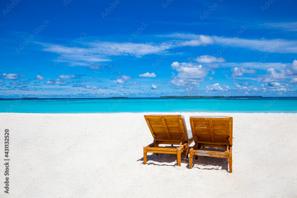 Minimal beach. Chairs on the sandy beach near the sea. Summer holiday and vacation, travel tourism. Inspirational tropical landscape. Tranquil scenery, relaxing beach, tropical landscape design Minimal beach. Chairs on the sandy beach near the sea. Summer holiday and vacation, travel tourism. Inspirational tropical landscape. Tranquil scenery, relaxing beach, tropical landscape design