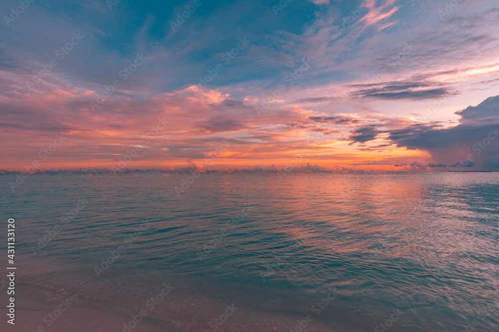 Relaxing seascape, sunset colorful sky with water reflection. seaside, coast, shore of ocean lagoon with bright golden yellow light. Tropical nature pattern, horizon and cloudy sky