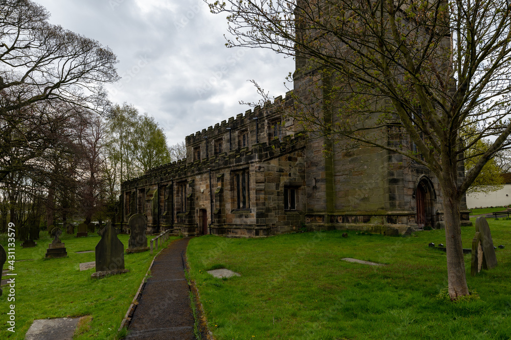 All Saints Church of England church built in 1517 and graveyard in Darton, South Yorkshire