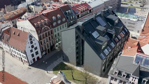 Beautiful aerial view of the Riga old town with St. Peters cathedral in the center and epic sunset sky.