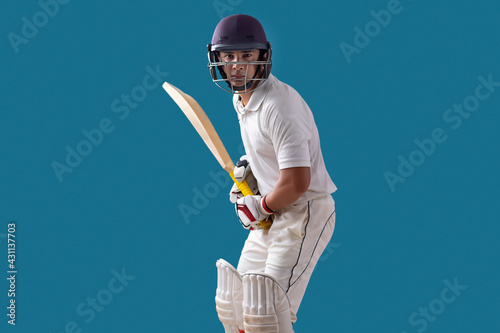  batsman ready to face the ball, isolated over Blue background	 photo