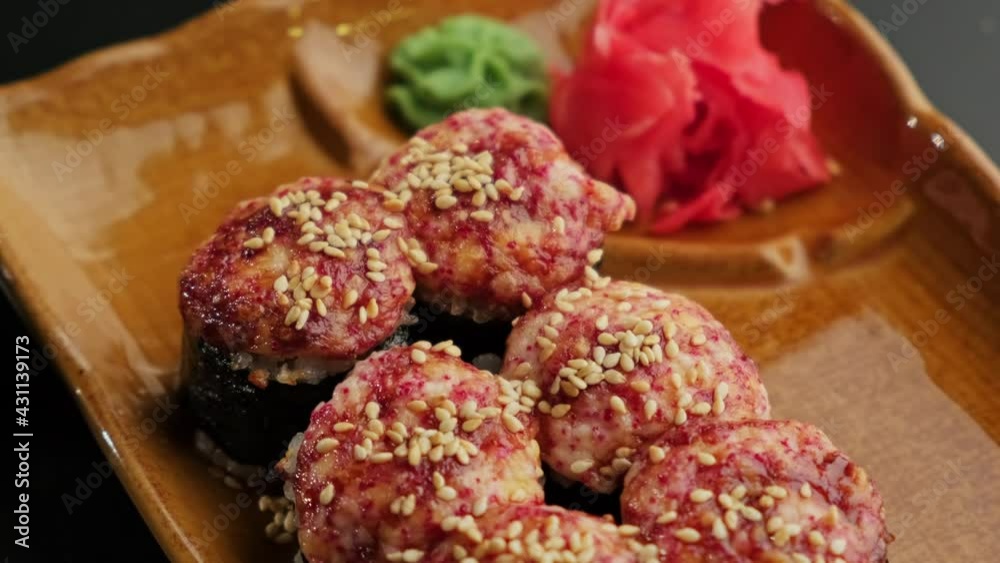 Sushi and rolls, Japanese sea cuisine. Served plates for the restaurant menu on a black background. Close-up.