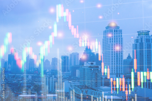 Double exposure of graph Stock market exchange on blurred photo of city scenery background  business trading  construction and technology concept.