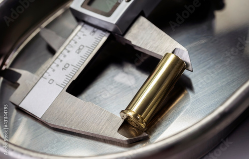 measures bullet caliber in ballistic lab, conceptual image