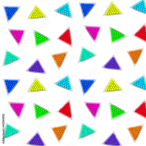 Seamless photo background of round acrylic colored beads in white triangular packages on a white background