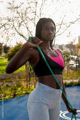 afro american young woman exercising in an urban cenario. Outdoor and lonely activity