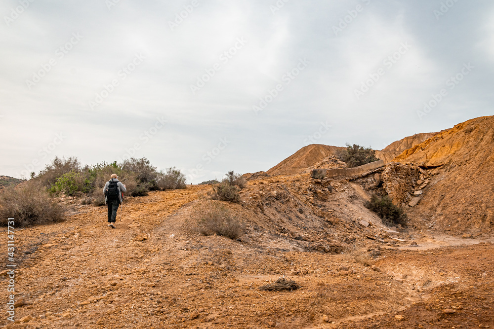 Man walking through the abandoned Mines of Mazarrón. Murcia region. Spain