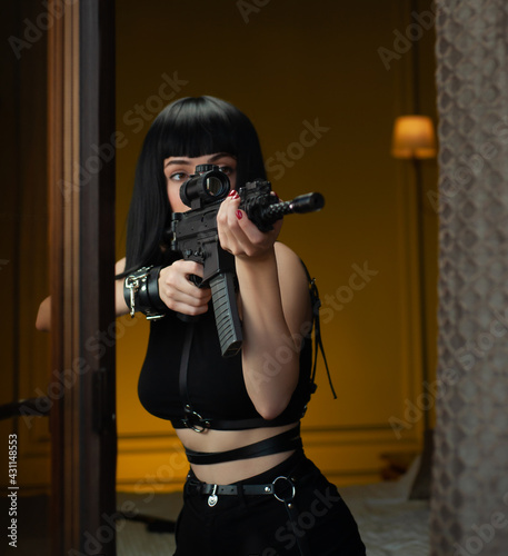 a female hitman in a hotel near the window aims an automatic rifle with a telescopic sight at the victim committing murder
