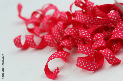 Dotty pink ribbon on white background with copy space

