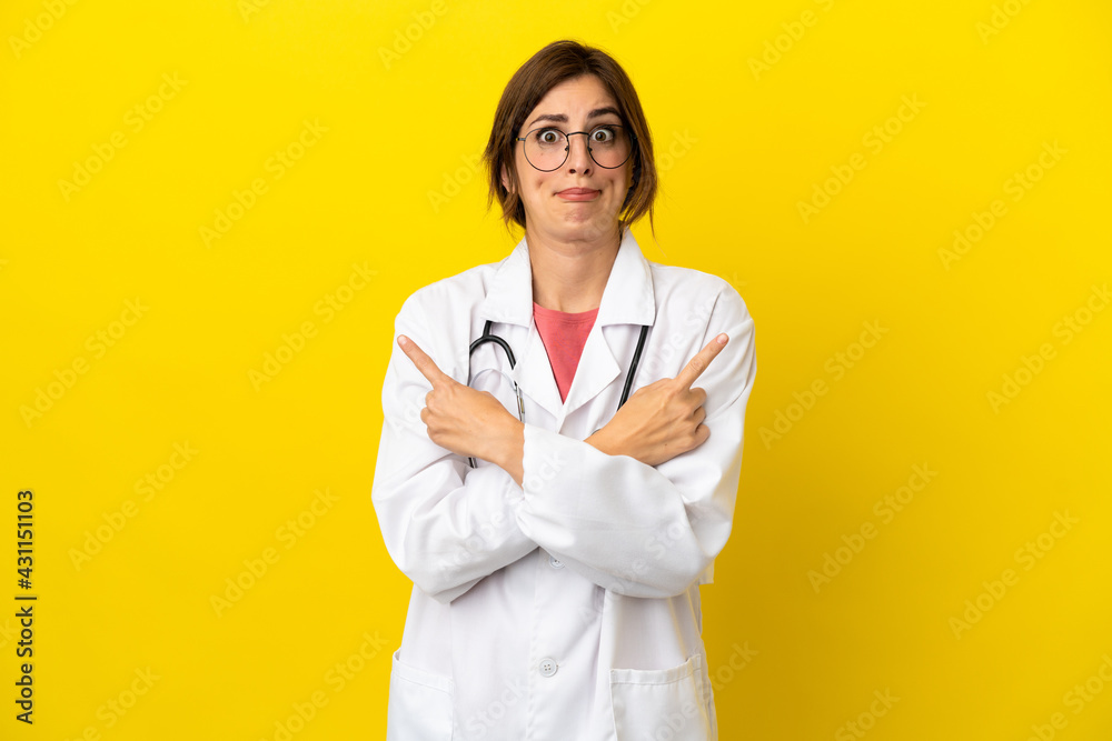 Doctor woman isolated on yellow background pointing to the laterals having doubts Doctor woman isolated on yellow background pointing to the laterals having doubts