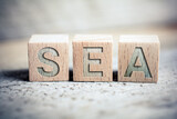 SEA Search Engine Advertising Written On Wooden Blocks On A Board - Business Marketing Concept