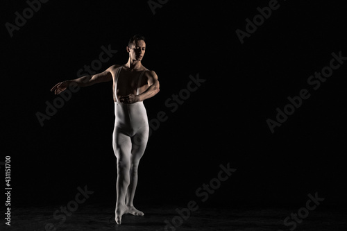 Male ballet dancer on a black background